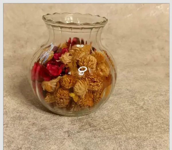 Clear glass vase filled with dried flower